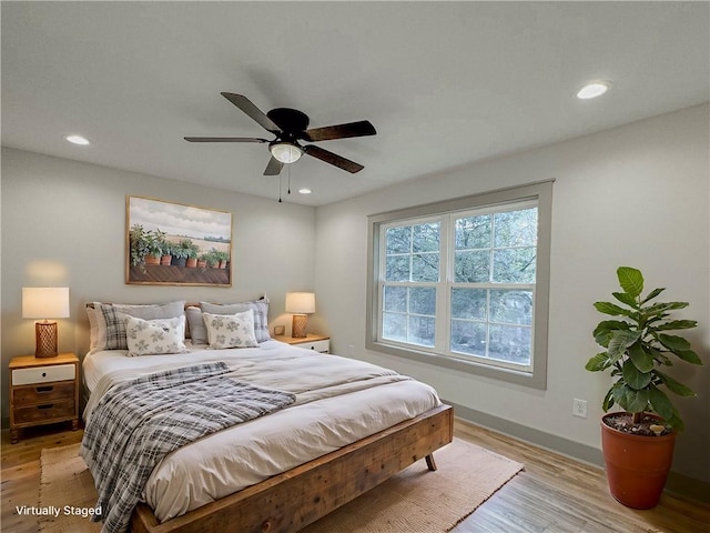 bedroom featuring ceiling fan and light hardwood / wood-style flooring