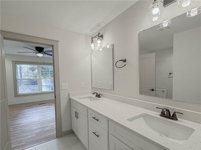 bathroom with ceiling fan, tile patterned floors, vanity, and toilet