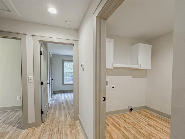 laundry area with electric dryer hookup, cabinets, washer hookup, and light hardwood / wood-style flooring