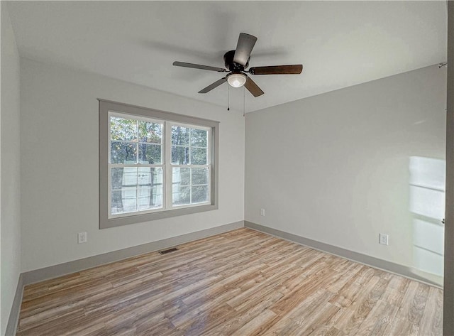 spare room with light wood-type flooring and ceiling fan