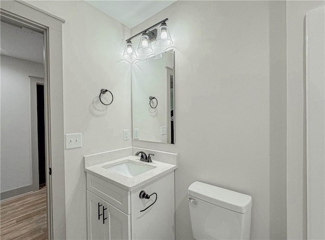 bathroom featuring hardwood / wood-style floors, toilet, and vanity