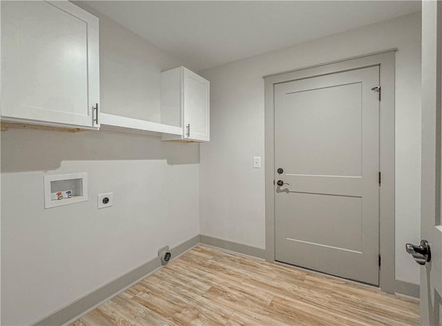 laundry area with hookup for an electric dryer, cabinets, hookup for a washing machine, and light wood-type flooring