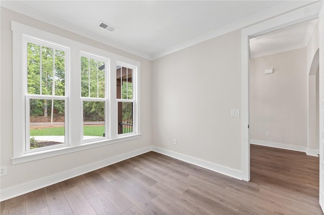 spare room with hardwood / wood-style flooring and ornamental molding