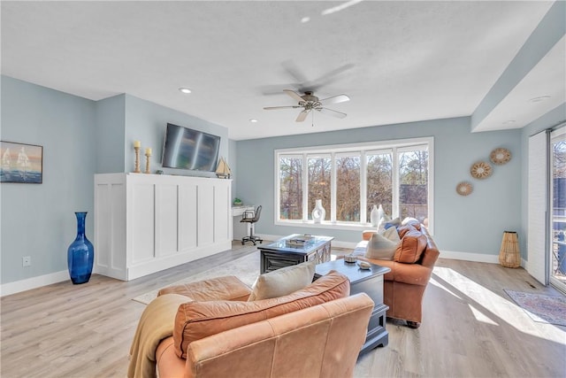 living room featuring light wood-type flooring and ceiling fan