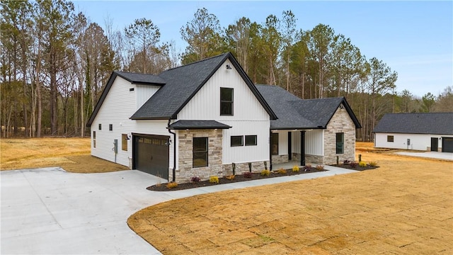 modern farmhouse featuring covered porch and a garage