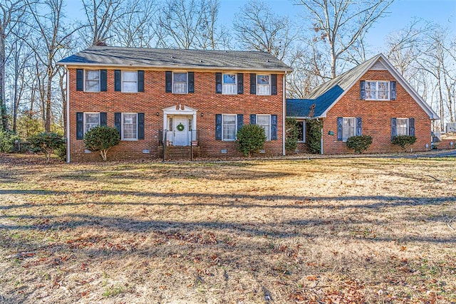 colonial-style house with a front lawn