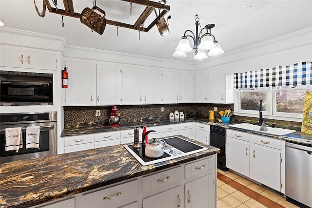 kitchen featuring hanging light fixtures, sink, white cabinetry, light tile patterned flooring, and stainless steel appliances