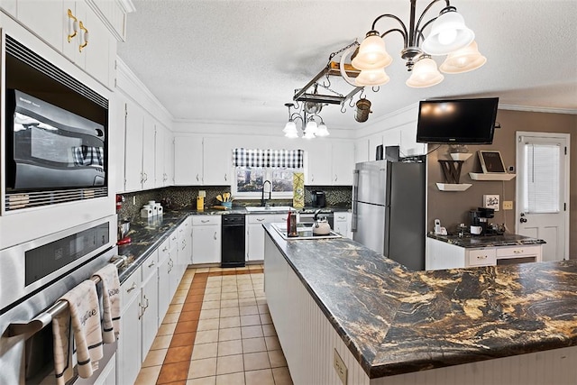 kitchen featuring a kitchen island, white cabinets, pendant lighting, and stainless steel appliances