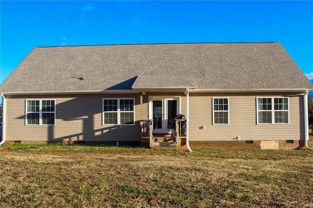 rear view of property with a lawn