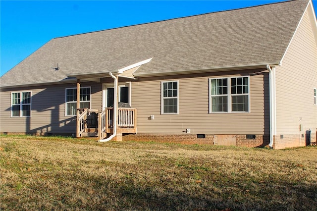 rear view of property with a yard