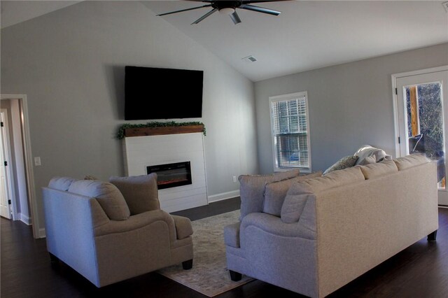 living room featuring vaulted ceiling, ceiling fan, and dark hardwood / wood-style floors