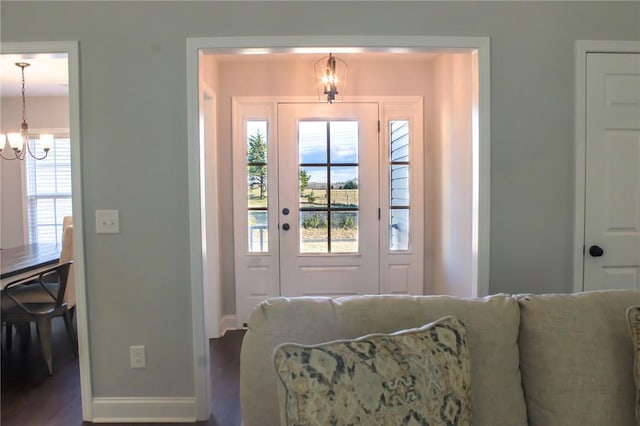 foyer entrance featuring hardwood / wood-style flooring and a chandelier