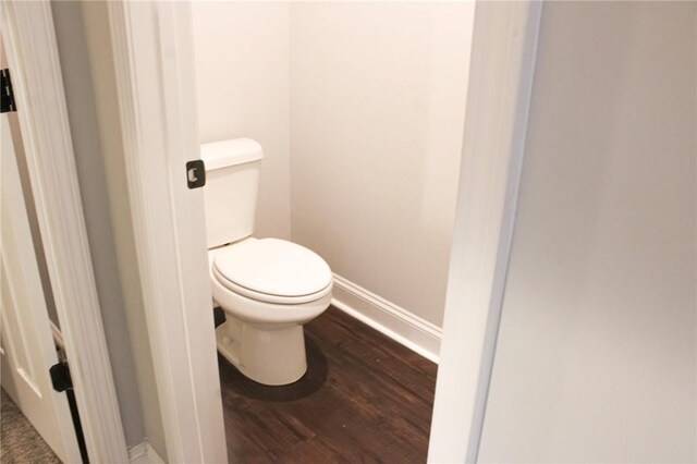 bathroom with toilet and hardwood / wood-style floors