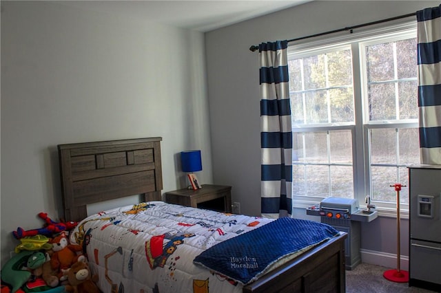 bedroom with multiple windows and carpet flooring