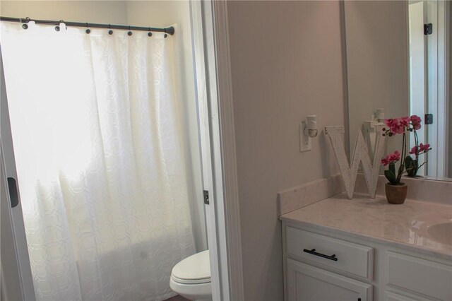 bathroom featuring vanity and toilet