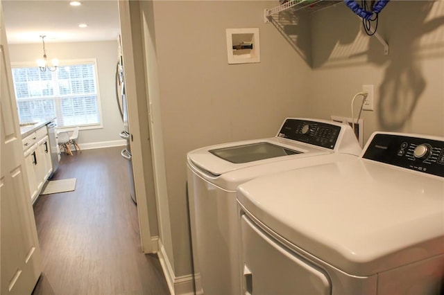 626 Johnny Long Rd, Iva, SC 29655 - clothes washing area with washing machine and clothes dryer, baseboards, laundry area, dark wood finished floors, and a notable chandelier