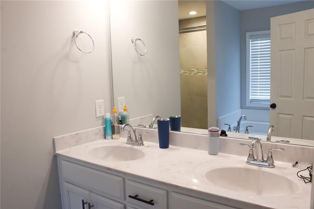 bathroom with vanity and a bath