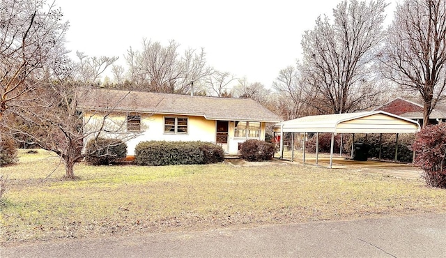 view of front of home with a front lawn and a carport