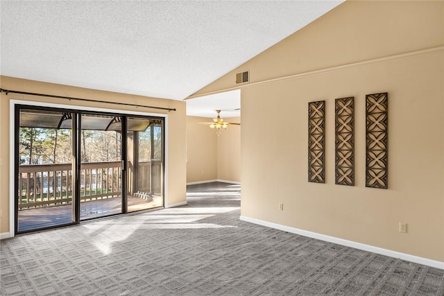 unfurnished room with ceiling fan, vaulted ceiling, a textured ceiling, and carpet