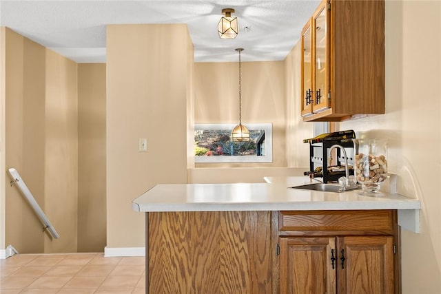 bar featuring decorative light fixtures, sink, and a textured ceiling