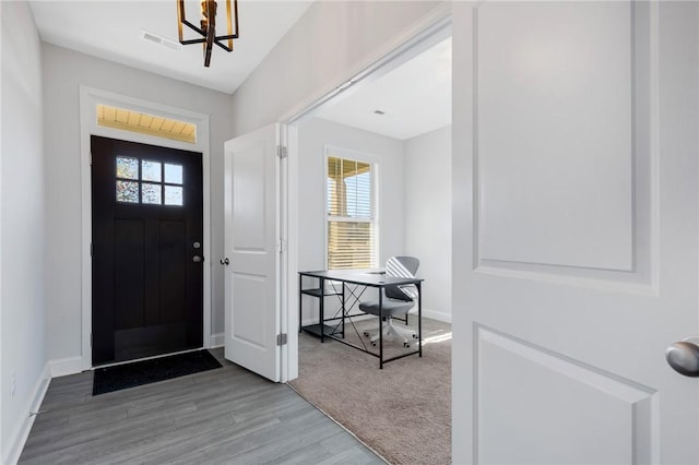 entrance foyer featuring an inviting chandelier and hardwood / wood-style floors