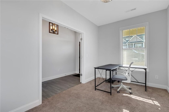 office space featuring an inviting chandelier, plenty of natural light, and carpet flooring