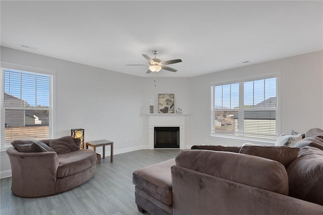 living room featuring hardwood / wood-style flooring and ceiling fan