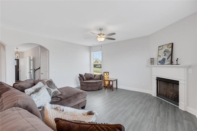 living room with ceiling fan and wood-type flooring