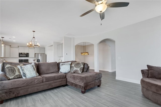 living room with light hardwood / wood-style flooring and ceiling fan