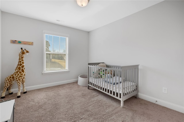 carpeted bedroom with a nursery area