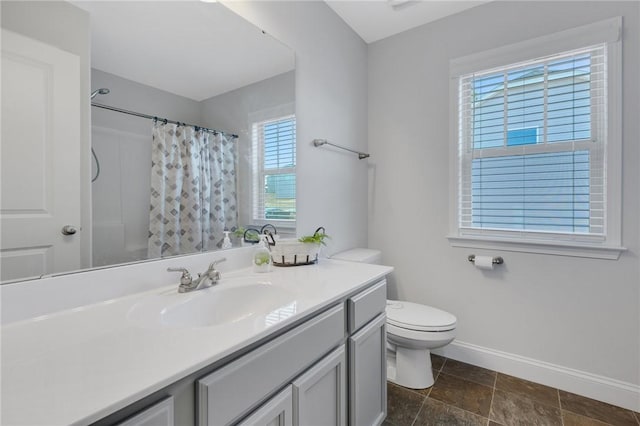 bathroom featuring vanity, plenty of natural light, curtained shower, and toilet