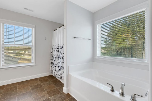 bathroom featuring separate shower and tub