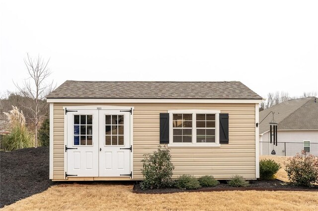 view of outbuilding with a lawn