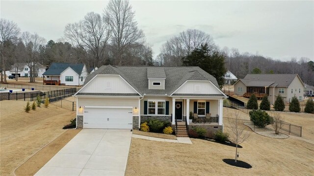 view of front of house featuring a garage and a porch