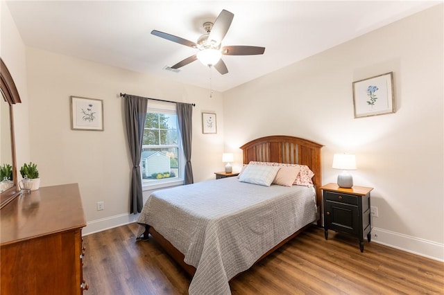 bedroom with visible vents, wood finished floors, a ceiling fan, and baseboards