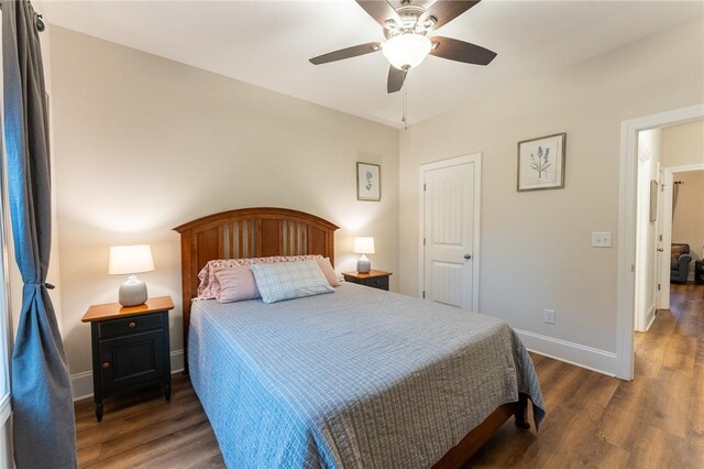 bedroom with ceiling fan and dark hardwood / wood-style flooring