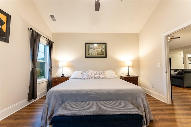 bedroom featuring dark wood-type flooring, vaulted ceiling, and ceiling fan