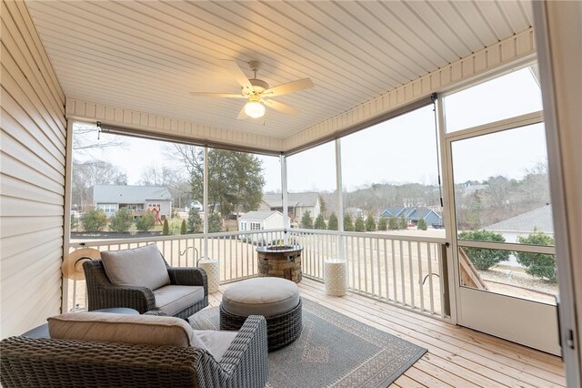 sunroom featuring ceiling fan