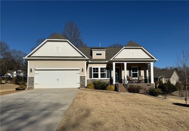 view of front facade with concrete driveway, a porch, and an attached garage