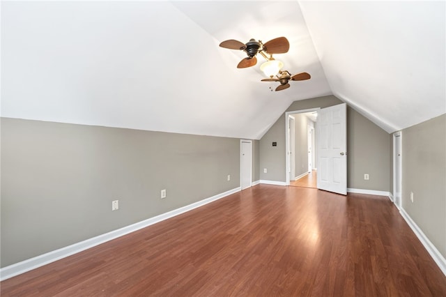 additional living space featuring vaulted ceiling, dark hardwood / wood-style floors, and ceiling fan