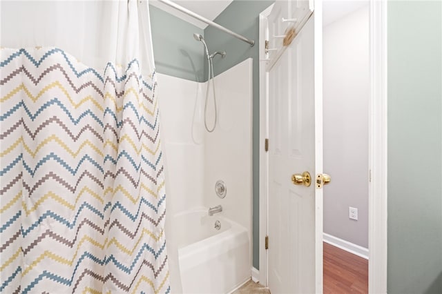 bathroom featuring wood-type flooring and shower / bath combination with curtain