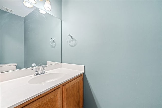 bathroom with vanity and toilet