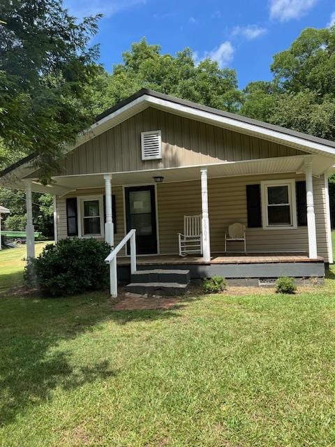 view of front of house with a porch and a front yard