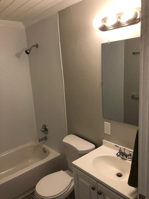 full bathroom with toilet, ornamental molding, vanity, and shower / bathing tub combination