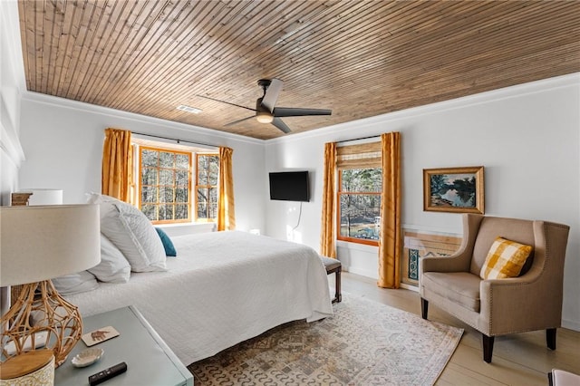 bedroom with ornamental molding, a ceiling fan, wood finished floors, and wooden ceiling