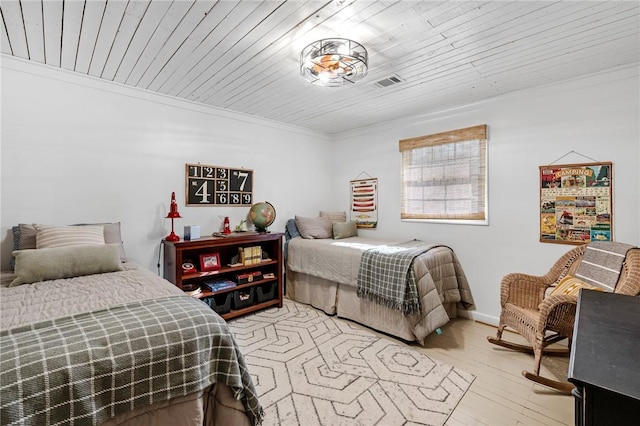 bedroom with visible vents, ornamental molding, wood ceiling, and light wood-type flooring