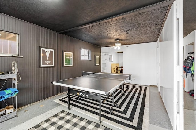 playroom featuring a ceiling fan and speckled floor