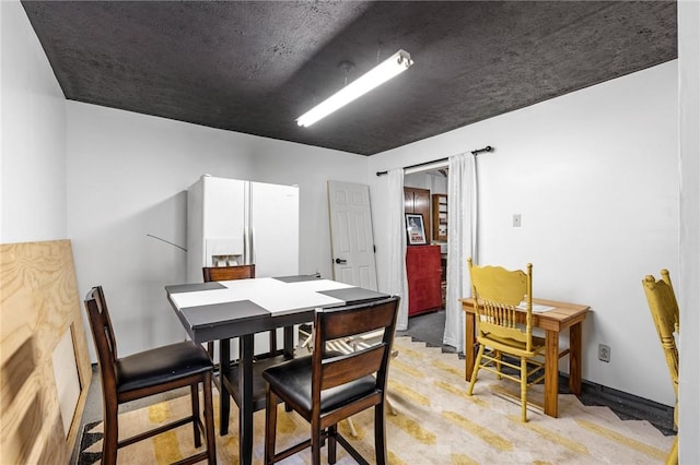dining area featuring light colored carpet