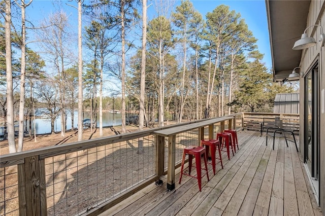 wooden deck featuring a water view