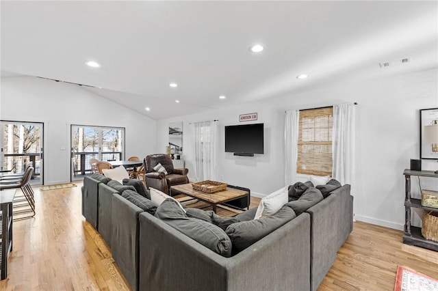 living area featuring light wood-style floors, baseboards, recessed lighting, and lofted ceiling
